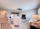 Bright living room with tile floors, comfortable seating and a ceiling fan at 11821 Boynton Ln, New Port Richey, FL 34654