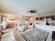 Comfortable living room featuring tile floors, soft lighting and a view into the dining area at 11821 Boynton Ln, New Port Richey, FL 34654