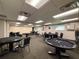 Well lit poker room featuring multiple tables and chairs, carpet flooring, and off-white painted walls at 11821 Boynton Ln, New Port Richey, FL 34654
