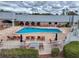 Well-maintained pool with chairs and building backdrop, perfect for leisure and recreation on a partly cloudy day at 11821 Boynton Ln, New Port Richey, FL 34654