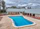 Relaxing pool area with chairs and well-maintained pool with blue water and lounge seating, perfect for leisure and recreation at 11821 Boynton Ln, New Port Richey, FL 34654