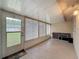 Enclosed sunroom with tile flooring, multiple windows, and access to the backyard at 11821 Boynton Ln, New Port Richey, FL 34654