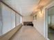 Enclosed sunroom with tile flooring, multiple windows, and a sliding glass door to the exterior at 11821 Boynton Ln, New Port Richey, FL 34654