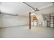 Unfinished basement area with laundry, water heater, and garage door at 12106 Bear Creek Ln, Hudson, FL 34667