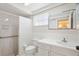All-white bathroom featuring a walk-in shower at 12106 Bear Creek Ln, Hudson, FL 34667