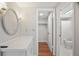 Bathroom area with a vanity, oval mirror, and a walk-in closet at 12106 Bear Creek Ln, Hudson, FL 34667