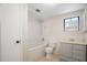 Bathroom featuring a white tub/shower combination, toilet and vanity with sink at 12106 Bear Creek Ln, Hudson, FL 34667