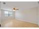Bedroom featuring light-colored hardwood floors, ceiling fan, and a window with blinds at 12106 Bear Creek Ln, Hudson, FL 34667