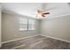 Bedroom with modern wood-look flooring, window, and neutral paint at 12106 Bear Creek Ln, Hudson, FL 34667