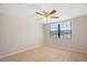 Bedroom featuring light-colored hardwood floors, ceiling fan, and a window with blinds at 12106 Bear Creek Ln, Hudson, FL 34667