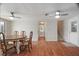 Open-concept dining area with hardwood floors, a wooden table, and access to the staircase at 12106 Bear Creek Ln, Hudson, FL 34667