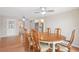 Dining room with wood floors and a modern ceiling fan fixture at 12106 Bear Creek Ln, Hudson, FL 34667