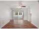 Dining room with hardwood floors, sliding glass doors to the pool, and access to the kitchen at 12106 Bear Creek Ln, Hudson, FL 34667