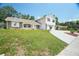 Charming two-story home with a spacious driveway, stone accents, and green lawn at 12106 Bear Creek Ln, Hudson, FL 34667