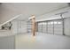 Spacious garage featuring washer, dryer, and a large garage door at 12106 Bear Creek Ln, Hudson, FL 34667