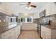 Bright kitchen with white cabinetry, stainless steel appliances, and ample counter space at 12106 Bear Creek Ln, Hudson, FL 34667