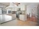 Well-lit kitchen featuring stainless steel appliances, tile backsplash, and tile floor at 12106 Bear Creek Ln, Hudson, FL 34667