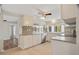 Bright kitchen with white cabinetry, stainless steel appliances, tile floor, and ample counter space at 12106 Bear Creek Ln, Hudson, FL 34667