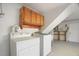 Laundry room with washer, dryer and cabinets above at 12106 Bear Creek Ln, Hudson, FL 34667