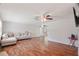 Spacious living room with beautiful hardwood floors, a comfortable couch, and ceiling fans at 12106 Bear Creek Ln, Hudson, FL 34667