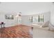 Bright living room with hardwood floors, a large window, and a comfortable sectional sofa at 12106 Bear Creek Ln, Hudson, FL 34667