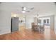 Open floorplan with wood flooring connects the kitchen, dining, and living spaces at 12106 Bear Creek Ln, Hudson, FL 34667