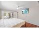 Light and airy main bedroom with a ceiling fan and sliding doors to the lanai at 12106 Bear Creek Ln, Hudson, FL 34667