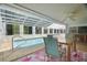 Indoor pool area with a ceiling fan, table, seating, and a view of the backyard at 12106 Bear Creek Ln, Hudson, FL 34667
