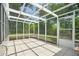 Spacious screened patio with tile flooring and a view of the backyard at 12106 Bear Creek Ln, Hudson, FL 34667