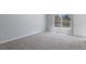 Bedroom with neutral walls, carpet flooring, and a large window at 12192 Eskimo Curlew Rd, Weeki Wachee, FL 34614