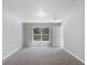 Empty bedroom with neutral walls, carpet flooring, and a window view at 12192 Eskimo Curlew Rd, Weeki Wachee, FL 34614