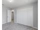 Cozy bedroom featuring closet, plush carpet and neutral walls creating a bright inviting atmosphere at 12192 Eskimo Curlew Rd, Weeki Wachee, FL 34614