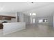Open-concept living room with tile floors and natural light from a large window at 12192 Eskimo Curlew Rd, Weeki Wachee, FL 34614