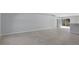 Bright and spacious living area with tile flooring, neutral walls, and sliding doors leading to the outdoors at 12192 Eskimo Curlew Rd, Weeki Wachee, FL 34614