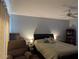 Tranquil bedroom featuring a comfortable bed, ceiling fan, and minimalist decor creating a serene atmosphere at 1221 Etta Ave, Spring Hill, FL 34609