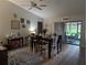 Open dining room with vaulted ceiling with a view of the patio and backyard through a sliding glass door at 1221 Etta Ave, Spring Hill, FL 34609