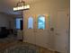 Welcoming entryway featuring double front doors with decorative glass panels and modern light fixture above round area rug at 1221 Etta Ave, Spring Hill, FL 34609