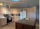 Well-appointed kitchen with an island, stainless steel appliances, and white cabinets providing ample storage space at 1221 Etta Ave, Spring Hill, FL 34609