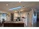 Bright and modern kitchen with island, white cabinets, track lighting, stainless steel appliances, and a skylight at 1221 Etta Ave, Spring Hill, FL 34609