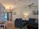 Cozy living room with vaulted ceiling featuring comfortable seating, wood laminate floors, and a view of the back patio at 1221 Etta Ave, Spring Hill, FL 34609
