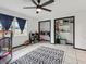 Bright bedroom with ceiling fan, closet, tile floors, and neutral decor, ideal for or guests at 1222 Huntington Ave, Spring Hill, FL 34609