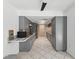 Galley kitchen features gray cabinetry, recessed lighting, and modern appliances for a sleek design at 1222 Huntington Ave, Spring Hill, FL 34609