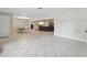 The open living area showcases tile floors and connects the dining area to an adjacent living area at 1222 Huntington Ave, Spring Hill, FL 34609