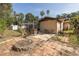 Expansive backyard with a fire pit, seating area, and screened-in pool enclosure for a relaxing outdoor experience at 12250 Lacey Dr, New Port Richey, FL 34654