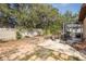 Spacious backyard featuring a fire pit, outdoor seating, and a screened-in patio for comfortable outdoor living at 12250 Lacey Dr, New Port Richey, FL 34654