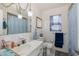 Well-lit bathroom featuring a classic sink, updated fixtures, and charming decor at 12250 Lacey Dr, New Port Richey, FL 34654