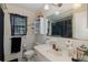 Cozy bathroom featuring white tiling, neutral countertops, and a classic sink with decorative light fixtures at 12250 Lacey Dr, New Port Richey, FL 34654