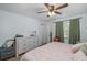 Bright bedroom with a fan, complemented by natural light from the window at 12250 Lacey Dr, New Port Richey, FL 34654