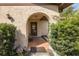 Welcoming arched front porch with cozy seating amidst lush greenery at 12250 Lacey Dr, New Port Richey, FL 34654