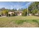 Charming single-story home with a well-maintained lawn and mature landscaping in a quiet neighborhood at 12250 Lacey Dr, New Port Richey, FL 34654